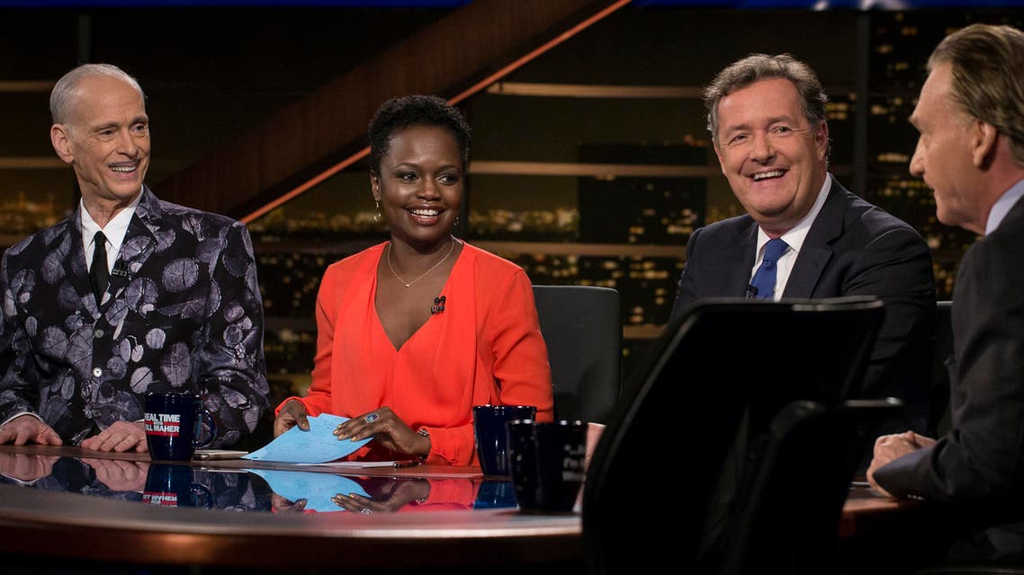 In this Friday, Feb. 10, 2017 photo provided by HBO, guests on a panel, John Waters, from left, filmmaker and author, Karine Jean-Pierre, senior advisor and national spokesman for MoveOn.org, and Piers Morgan, U.S. editor-at-large DailyMail.com, speak with host Bill Maher on the show, ”Real Time with Bill Maher,” in Los Angeles. Morgan and British author J.K. Rowling are in a Twitter war over American politics. He called her work “drivel” and she called him “amoral” after Morgan defended the U.S. government’s travel ban during an appearance on HBO’s “Real Time with Bill Maher” Friday. (Janet Van Ham/HBO via AP)