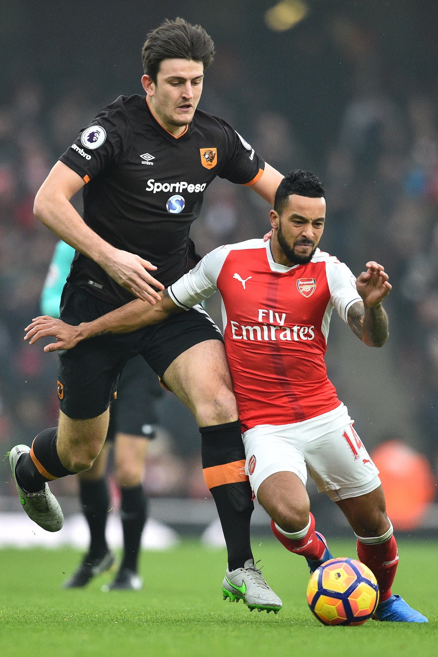Theo Walcott (L) and Harry Maguire (R) AFP.