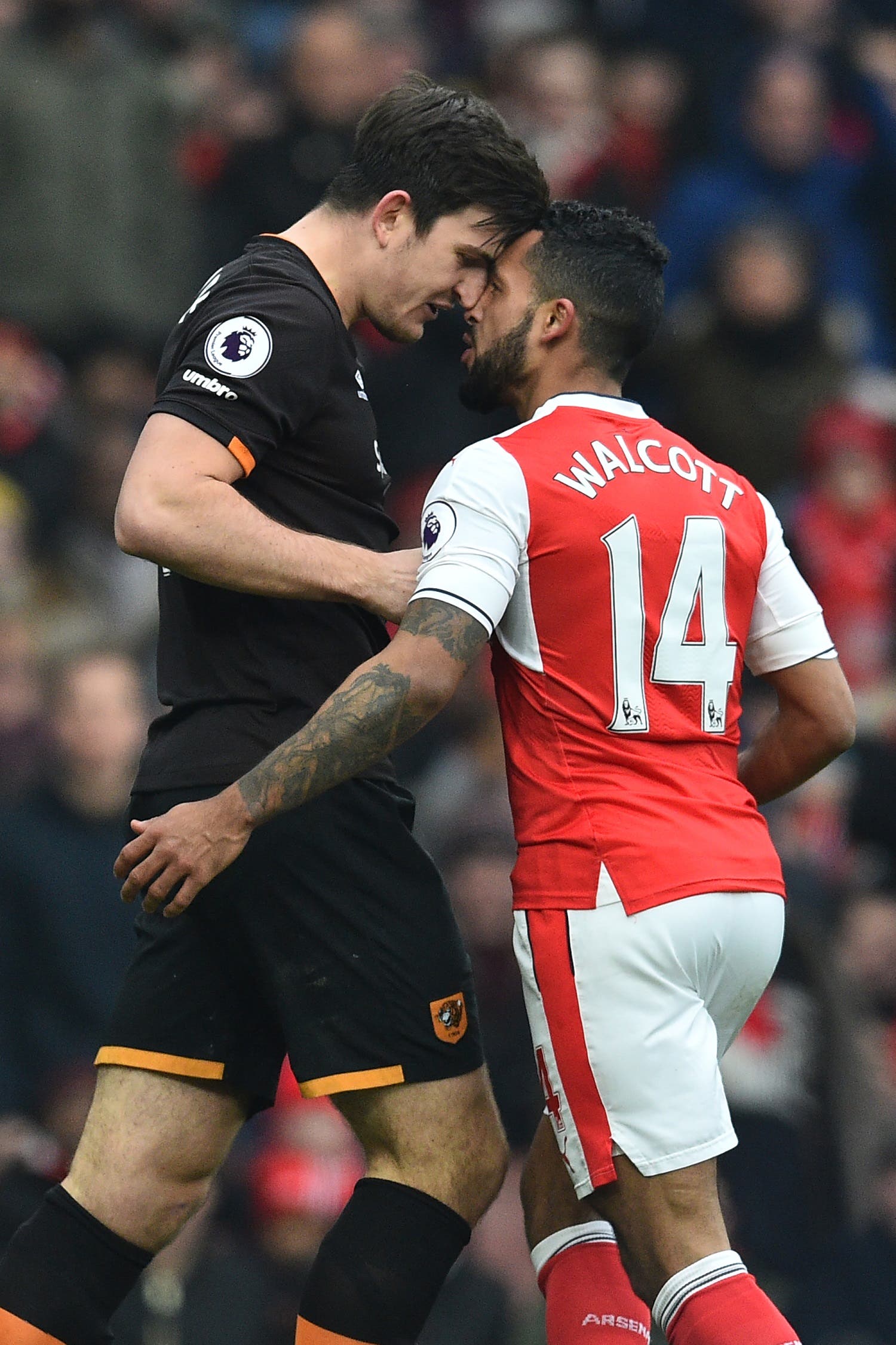 Theo Walcott (R) and Harry Maguire (L) AFP.