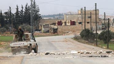 Opposition fighters backing Turkish troops drive past stones blocking a road in the village of Hazwan on the outskirts of the Syrian town of al-Bab as they advance towards the town which is the last stronghold of the Islamic State (IS) group in Syria's Aleppo's province on February 12, 2017. 