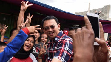 Jakarta governor Basuki Tjahaja Purnama (C) take pictures with residents during his campaign at Jatinegara district in Jakarta, Indonesia, February 6, 2017 in this photo taken by Antara Foto. Picture taken February 6, 2017. Antara Foto/Hafidz Mubarak/ via REUTERS ATTENTION EDITORS - THIS IMAGE WAS PROVIDED BY A THIRD PARTY. FOR EDITORIAL USE ONLY. MANDATORY CREDIT. INDONESIA OUT.