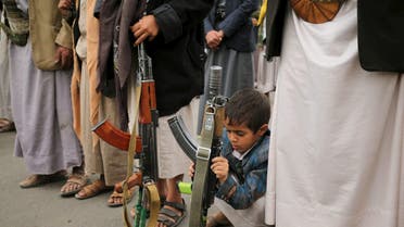 A boy holds his father's rifle during a rally by followers of the Houthi movement against the Saudi-led coalition in Yemen's capital Sanaa, August 11, 2015. afp