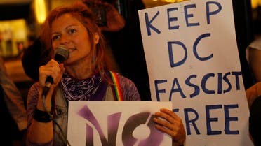 Members of DC Antifascist Coalition protest in opposition to a conference by the National Policy Institute in front of the Magliano’s restaurant in Washington, DC on November 18, 2016. (AFP)