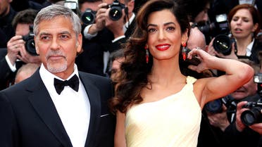 Cast member George Clooney and his wife Amal pose on the red carpet as they arrive during the 69th Cannes Film Festival in Cannes, France on May 12, 2016