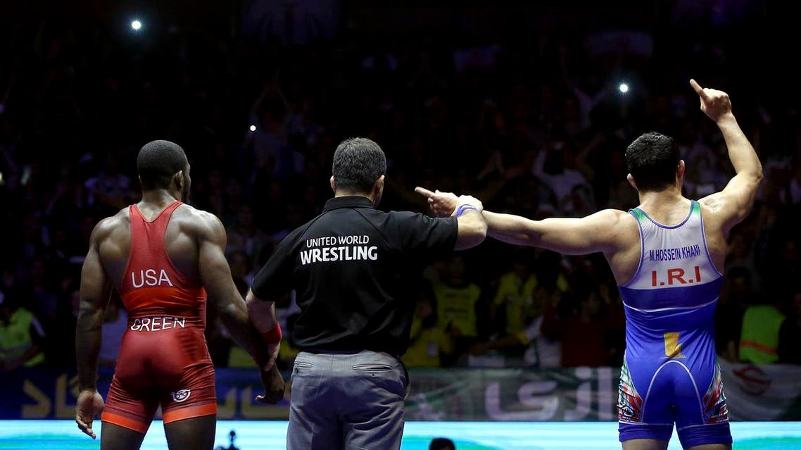 In this photo released by the Iran Newspaper, Iran’s wrestler Mostafa Hossein Khani, right, celebrates after defeating United States' wrestler James Green during the men's freestyle 70 freestyle wrestling competition (Photo: Naeim Ahmadi, IIPA via AP)