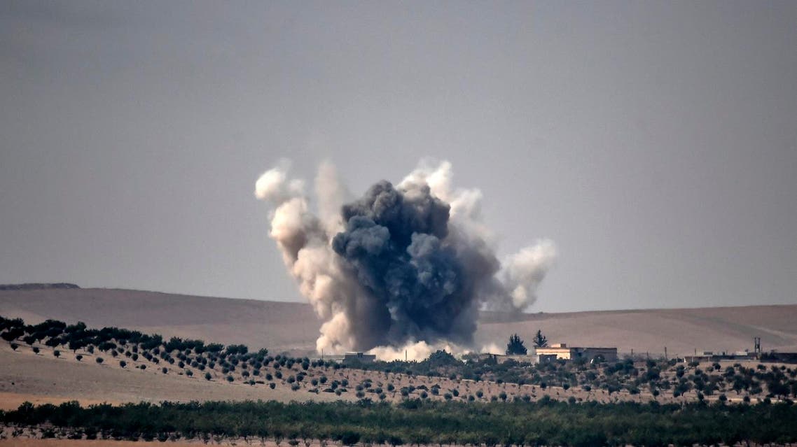 This picture taken from the Turkish Syrian border city of Karkamis in the southern region of Gaziantep, on August 24, 2016 shows smoke billows following air strikes by a Turkish Army jet fighter on the Syrian Turkish border village of Jarabulus during fighting against IS targets. AFP