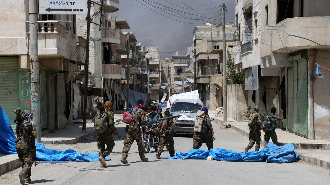 Members of the Syrian Democratic Forces (SDF) patrol a street in the northern Syrian town of Manbij on August 7, 2016, as they comb the city in search of the last remaining jihadists, a day after they retook it from the Islamic State group