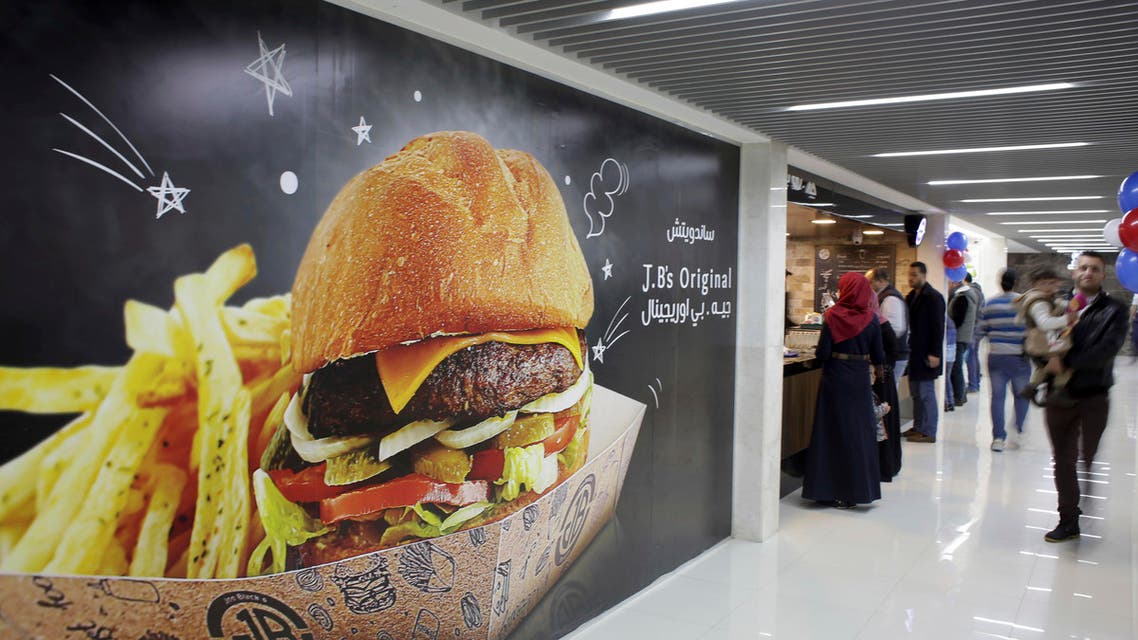 Palestinians buy fast food from the food court in the first indoor shopping mall in the Gaza Strip, in Gaza City. (AP)