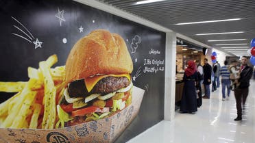 Palestinians buy fast food from the food court in the first indoor shopping mall in the Gaza Strip, in Gaza City. (AP)