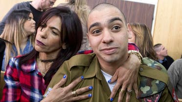 Israeli soldier Elor Azaria (R), who shot dead a wounded Palestinian assailant in March 2016, is embraced by his mother Oshra (L) at the start of his sentencing hearing in a military court in Tel Aviv on February 21, 2017. (AFP)