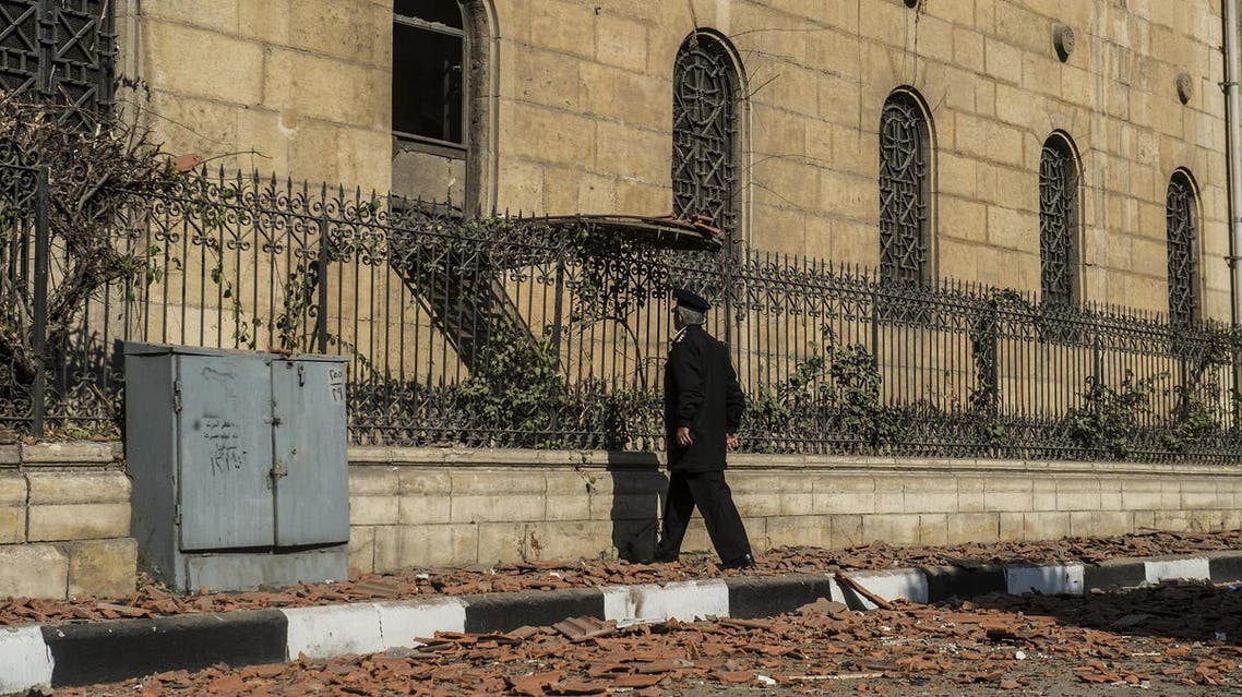 A policeman inspects the scene of a bomb explosion that targeted the Saint Peter and Saint Paul Coptic Orthodox Church on December 11, 2016, in Cairo’s Abbasiya neighborhood. (AFP)
