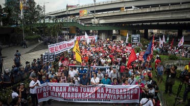 Activists march on the EDSA highway on their way to protest in front of the Armed Forces of the Philippines (AFP) headquarters in Manila on February 25, 2017, during the 31st anniversary of the "People Power" revolution. More than 1,000 people took to the streets of Manila on February 25 to protest Philippine President Rodrigo Duterte's brutal war on drugs, following the arrest of his most high-profile critic. (AFP)