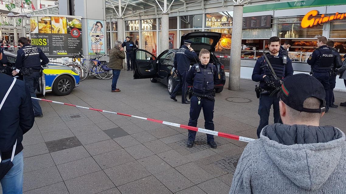 A car stands in front of a store, guarded by police in Heidelberg, Germany on Saturday. (AP)