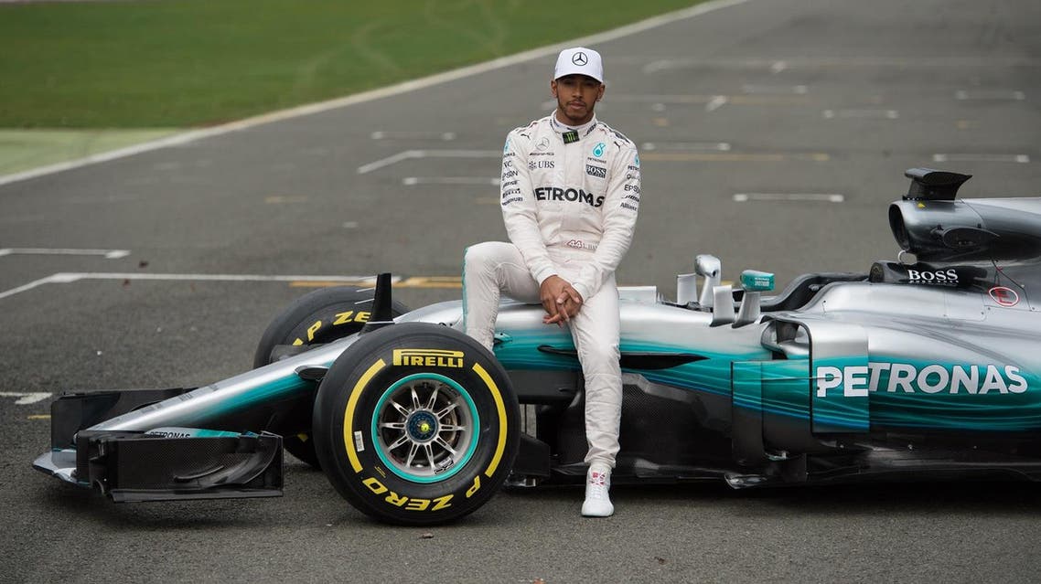 Mercedes AMG Petronas Formula One driver Britain's Lewis Hamilton poses by the new 2017 season Mercedes W08 EQ Power+ Formula One car at its launch event at Silverstone motor racing circuit near Towcester, central England on February 23, 2017. (AFP)