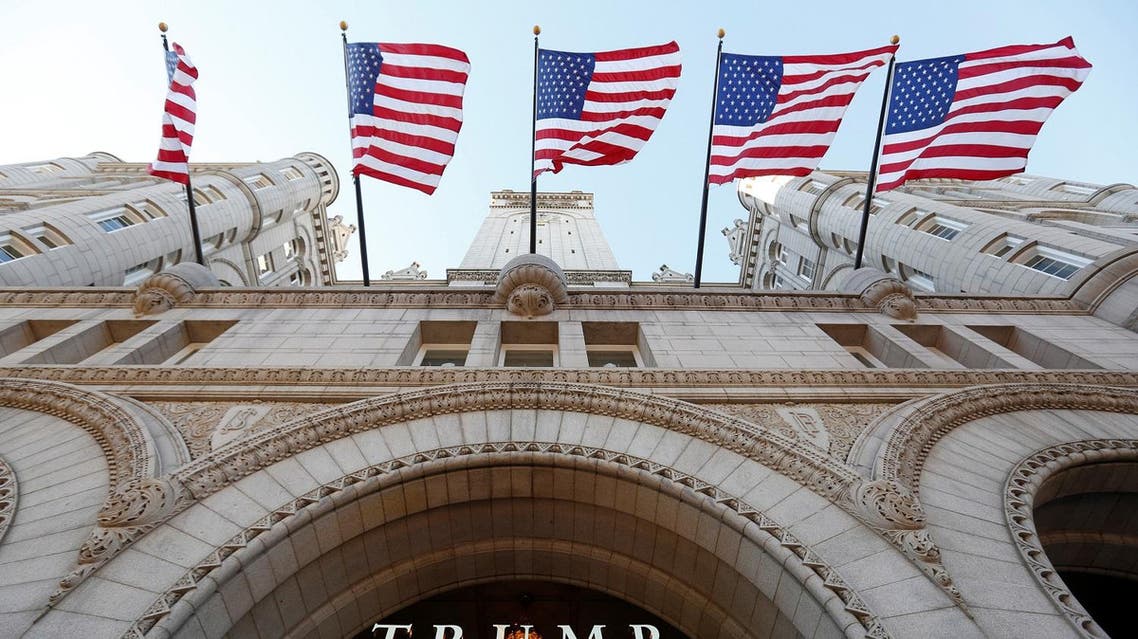 Flags fly above the entrance to the new Trump International Hotel on its opening day in Washington, DC. (File photo: Reuters)