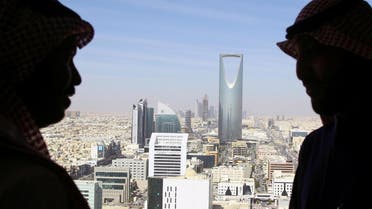 Men look out of a building at the Kingdom Centre Tower in Riyadh, Saudi Arabia, January 1, 2017. (Reuters)
