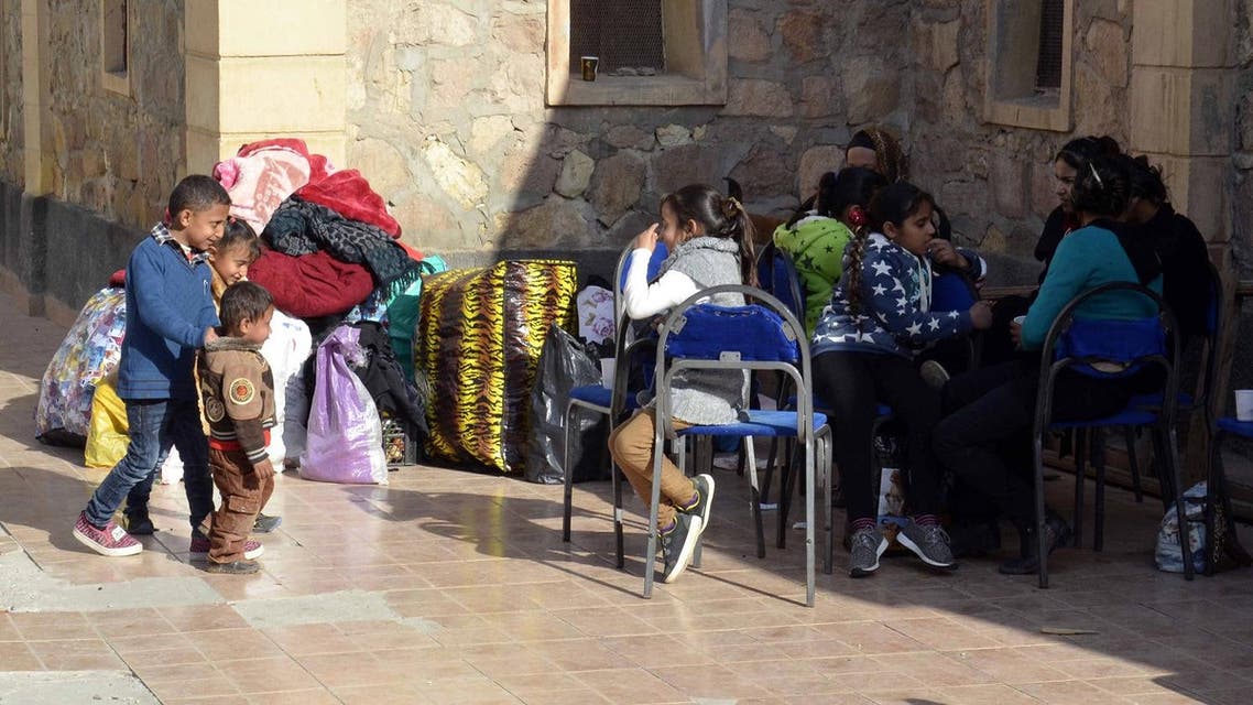 Egyptian Coptic Christians sit in the courtyard of the Evangelical Church in the Suez Canal city of Ismailiya on February 24, 2017, upon arriving to take refuge from Islamic State (IS) group jihadists. Dozens of Coptic Christians have left Egypt's Sinai Peninsula after a string of jihadist attacks killed three Christians in the restive province, church officials said. STRINGER / AFP