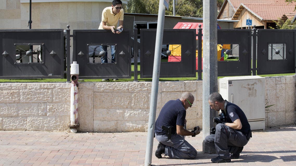 Israeli forensic policemen check the area after a rocket fired from the Gaza Strip hit in the southern Israeli town of Sderot, a few kms away from the Hamas-run Palestinian coastal territory, on October 5, 2016.