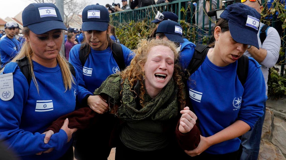 An Israeli youth supporter of settlements cries as Israeli police forces move protestors away from a house which is due to be demolished in the settlement of Ofra in the occupied West Bank, on February 28, 2017. (AFP)