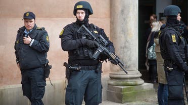 Danish policemen stand guard in front of the city court in Copenhagen, Denmark, where a trial is to open on March 10, 2016