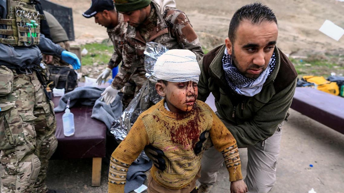 A boy injured in a mortar attack walks toward an ambulance after being treated by medics in a field clinic as Iraqi forces battle with ISIS militants, in western Mosul. (Reuters)