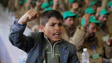 A boy shouts slogans next to pro-Houthi fighters, who have been injured during recent fighting, during a rally held to honour those injured or maimed while fighting in Houthi ranks in Sanaa, Yemen January 29, 2017. reuters