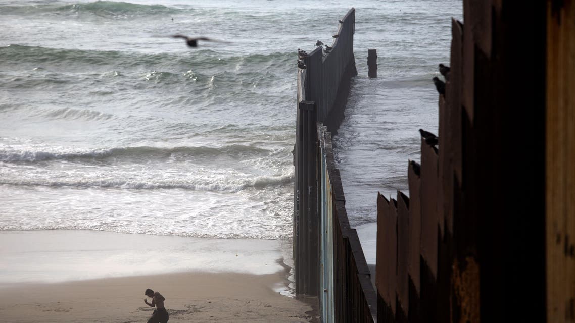 This photo taken on February 14, 2017 shows a man working out on the beach next to the Mexico-US border at Playas de Tijuana, northwestern Mexico. Built to keep out migrants, traffickers, or an enemy group, border walls have emerged as a one-size-fits-all response to the vulnerability felt by many societies in today's globalized world, says an expert on the phenomenon.