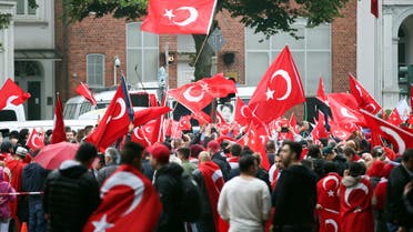 Turkish community gathers with flags in front of the Turkish Consulate in Hamburg, northern Germany, on July 16, 2016, to protest against a military coup attempt in Turkey