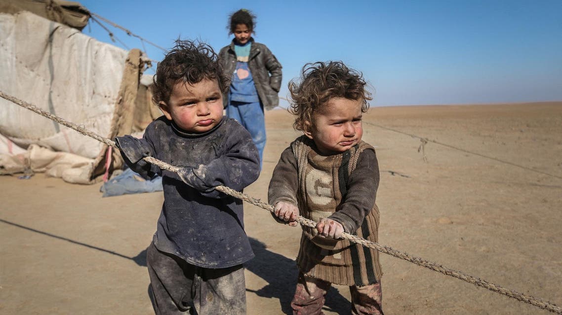 Internally displaced Syrian children who fled Raqqa city stand near their tent in Ras al-Ain province. (Reuters)