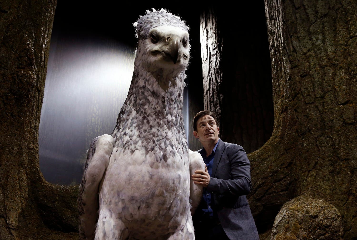 Actor Jason Isaacs poses for the media next to Buckbeak at a new extension called the 'Forbidden Forest' to the Warner Brothers studio tour 'The Making of Harry Potter' in Watford, England, Wednesday, March 8, 2017. (AP)