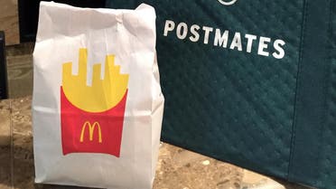 A bag of food from McDonald's ordered through the Postmates service sits next to a Postmates delivery bag during a delivery in New York on Wednesday, May 6, 2015. McDonald’s on Monday. May 5, 2015 became the latest chain to announce that it’s teaming up with Postmates to offer delivery as a pilot program in New York City, following similar announcements by Chipotle and Starbucks. (AP)