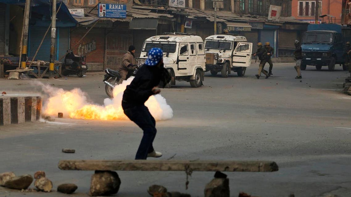A Kashmiri civilian crosses a road as a tear gas shell directed towards protestors explodes near him in Srinagar, Indian controlled Kashmir, Dec. 30, 2016. (File Photo: AP)