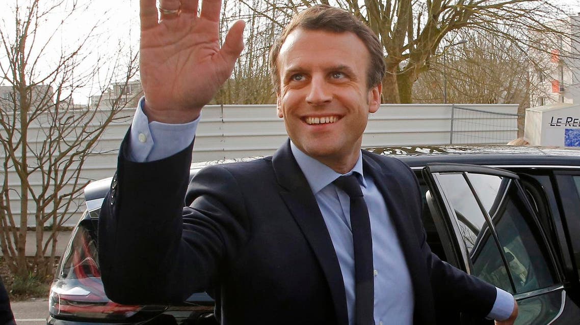 Emmanuel Macron waves to by standers as he arrives to visit the Moliere school in Les Mureaux, west of Paris, on March 7, 2017. (AP)