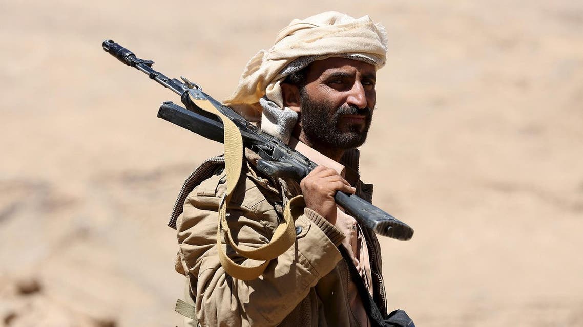 A pro-government government tribal fighter carries his weapon as he walks in Fardhat Nahm area, which has recently been taken by the army from Houthi rebels around 60km (40 miles) from Yemen's capital Sanaa, February 20, 2016. REUTERS