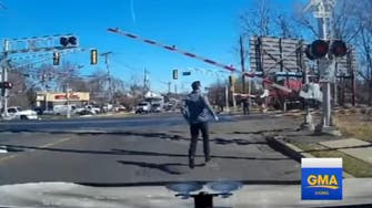 WATCH: Man jumps out of car to save woman from oncoming train