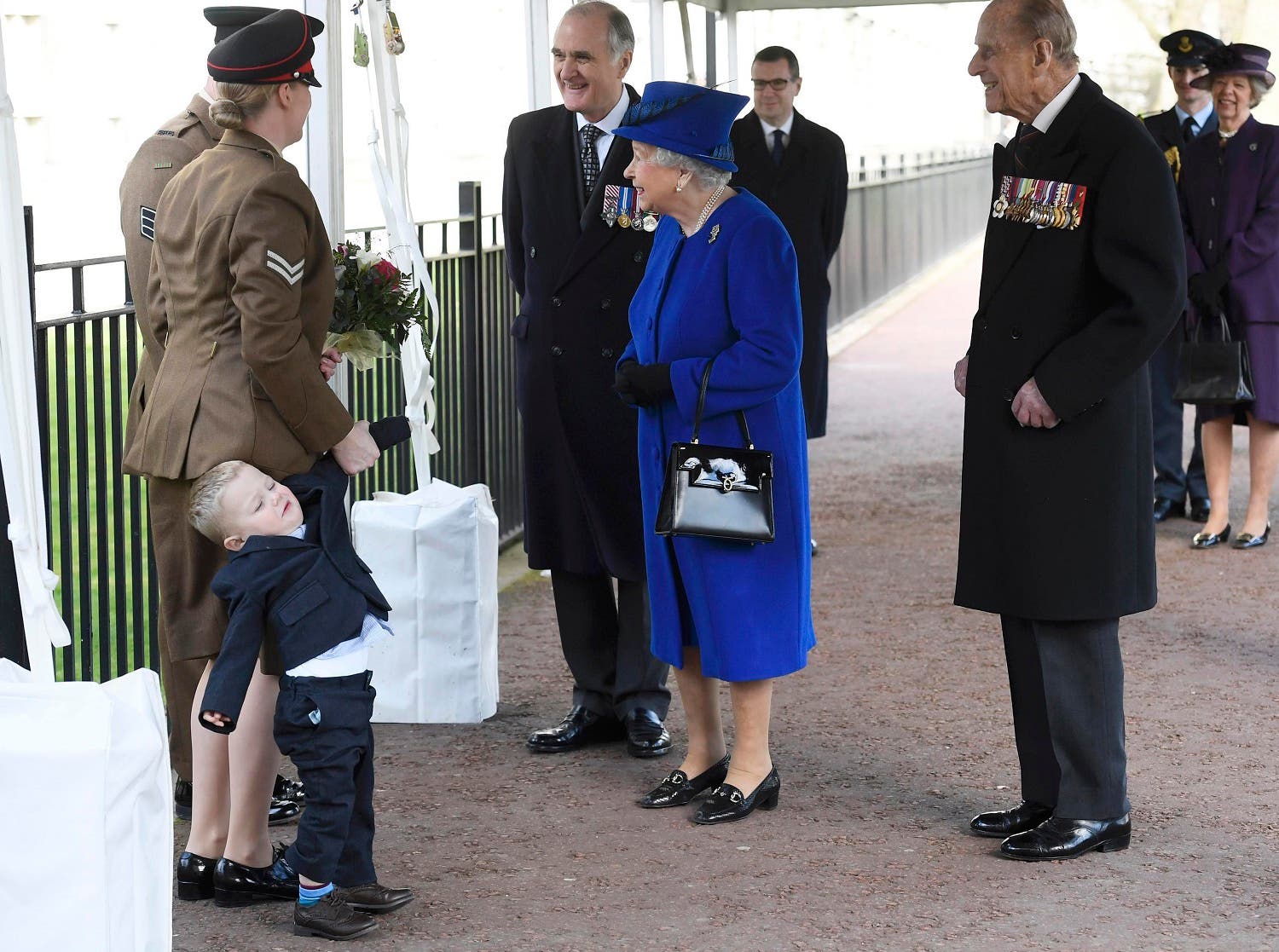 Michelle Lun, left, holds on to her son Alfie, 2-years-old as they meet Britain's Queen Elizabeth II at the unveiling during the the unveiling of a national memorial honouring the Armed Forces and civilians who served their country during the Gulf War and conflicts in Iraq and Afghanistan in London Thursday March 9, 2017. (AP)