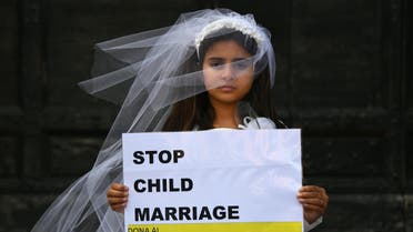 A young actress plays the role of Giorgia, 10, forced to marry Paolo, 47, during a happening organised by Amnesty International to denounce child marriage, on October 27, 2016 in Rome. afp 