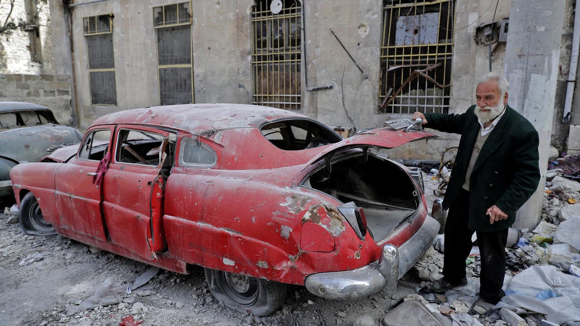 A picture taken on March 9, 2017, shows 70-year-old Mohammad Mohiedine Anis opening the trunk of his 1949 Hudson Commodor outside his home in Aleppo's formerly rebel-held al-Shaar neighbourhood. AFP