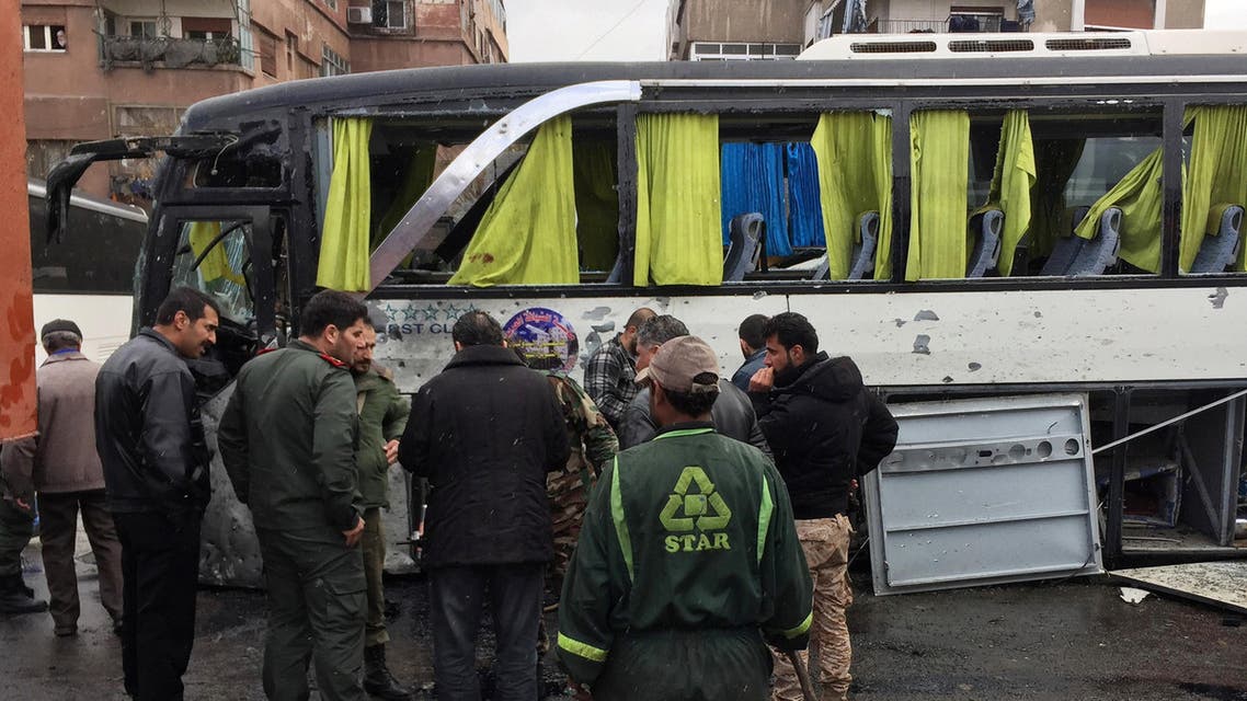 Syrian army soldiers and civilians inspect the damage at the site of an attack by two suicide bombers in Damascus, Syria March 11, 2017. REUTERS/Omar Sanadiki