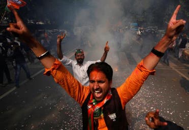 Supporters of  Bharatiya Janata Party celebrate after learning of the initial poll results outside the party headquarters in New Delhi, on March 11, 2017. (Reuters)