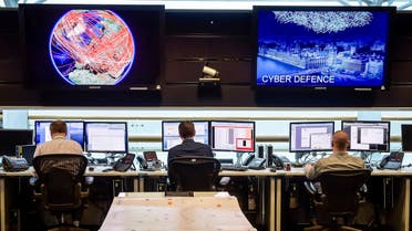 People sit at computers in the 24 hour Operations Room inside GCHQ, Cheltenham in Cheltenham, England, November 17, 2015