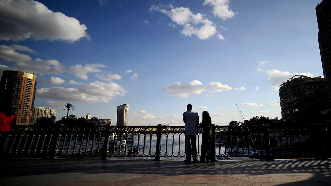 An Egyptian couple stands on a bridge overlooking the Nile River in downtown Cairo. (AFP)