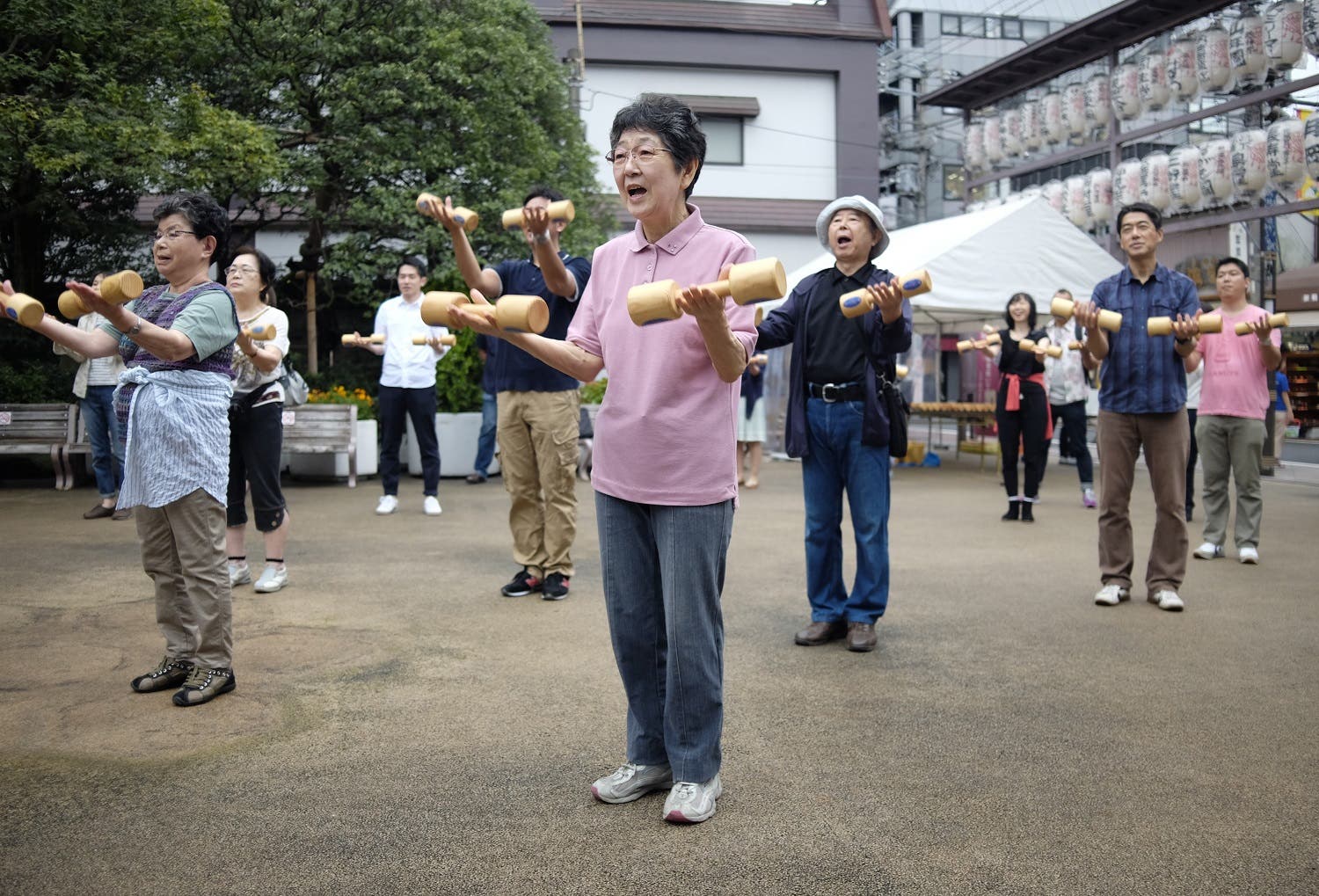 Elderly people work out with wooden dumb-bells in the grounds of a temple in Tokyo on September 19, 2016, to celebrate Japan's Respect for the Aged Day. (AFP)
