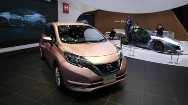 Nissan Motor's latest passenger vehicle 'Note' (L) and an electric concept vehicle 'BladeGlider' (R) are displayed at a showroom in Tokyo on February 23, 2017. (AFP)