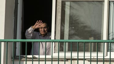 This file photo taken on October 6, 2016 shows Egypt's former president Hosni Mubarak waving to people from his room at the Maadi military hospital in Cairo, as his supporters gather to celebrate the 43rd anniversary of October War victory. (AFP)