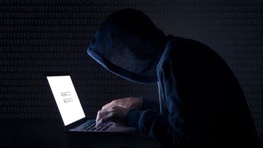 Hacker with laptop initiating cyber attack 