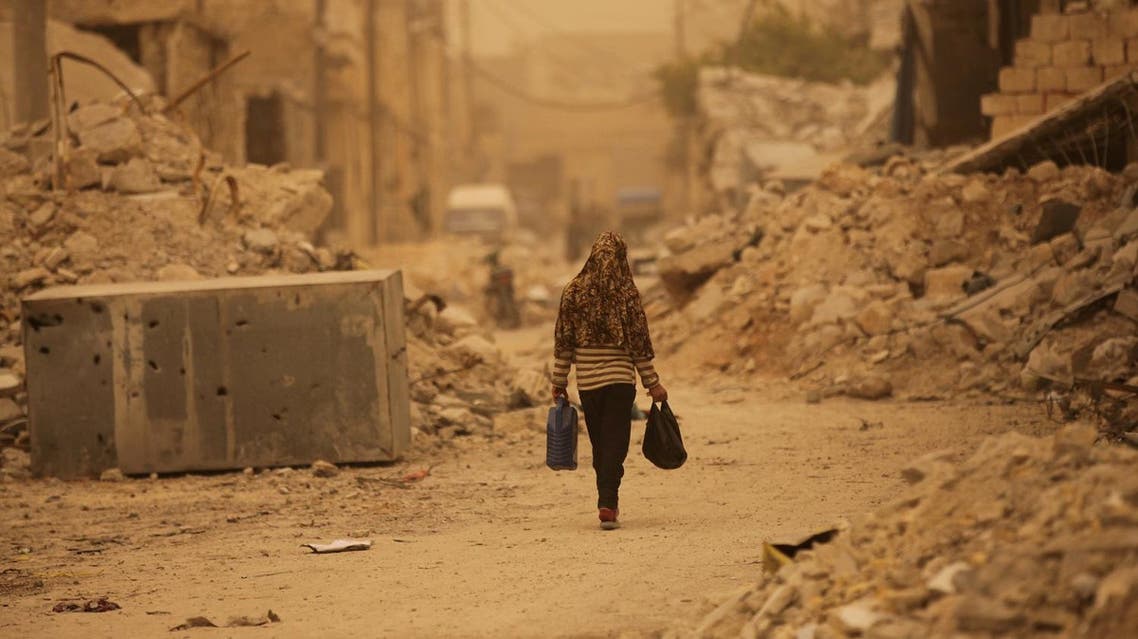 A civilian walks along a street during a dust storm in the northern Syrian town of al-Bab, Syria March 10 2017. REUTERS