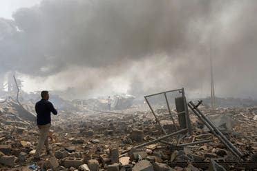A man walks at a destroyed building at the site of a blast caused by a fire at a weapons storage in eastern Baghdad, Iraq, September 2, 2016. (Reuters)