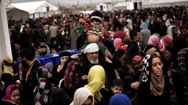 Displaced Iraqis from Mosul arrive at the Hamam al-Alil camp on March 13, 2017, during the government forces ongoing offensive to retake the western parts of the city from Islamic State (IS) group fighters. (AFP)