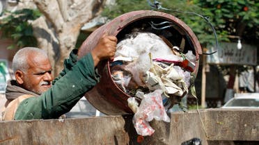 In this Thursday, Aug. 16, 2012 photo, a waste collector unloads garbage at a container in Cairo. (AP)